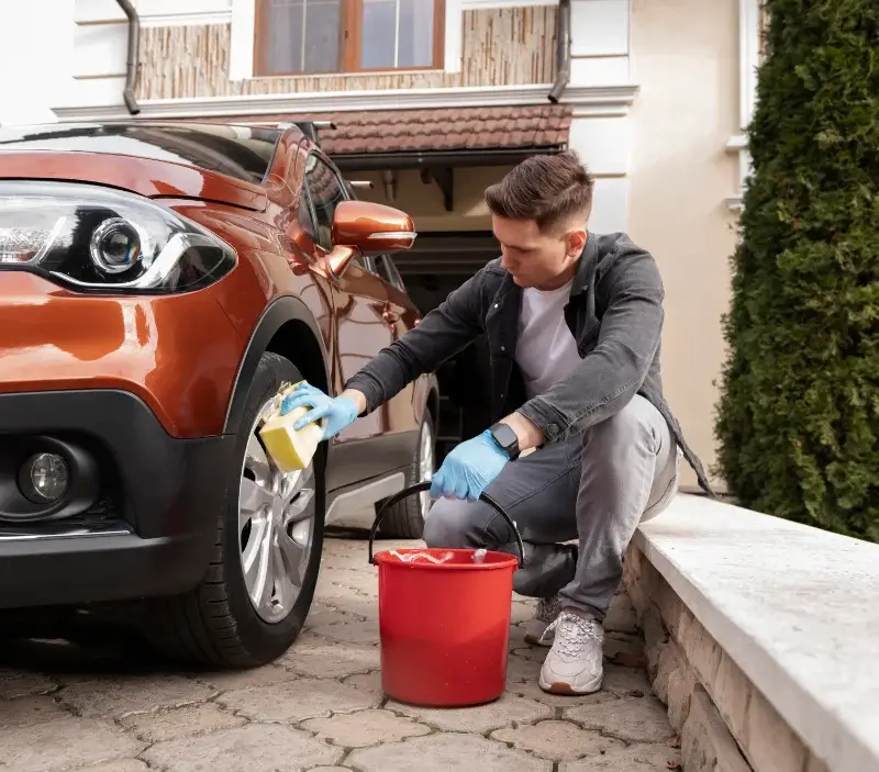 Lavage auto à domicile Saint-Pons-la-Calm : professionnel intervenant sur un véhicule